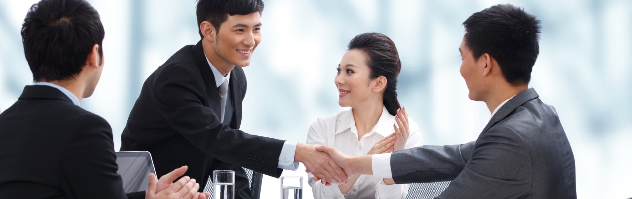 Businesspeople shaking hands at meeting